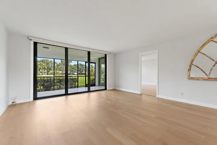 Natural light pours in through sliders and a signature arched window