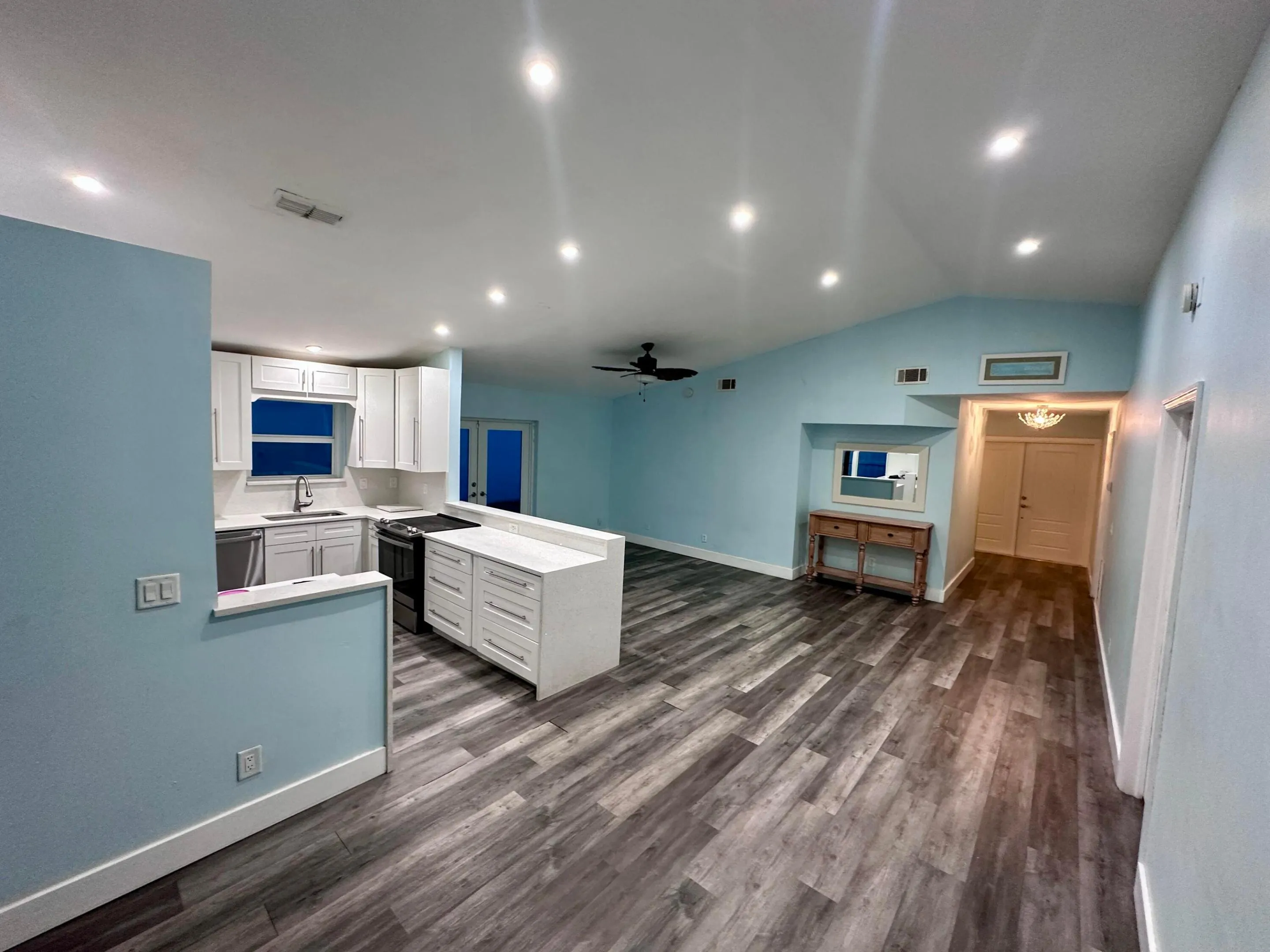 Open layout kitchen, dining area, and living room for effortless living and entertaining.