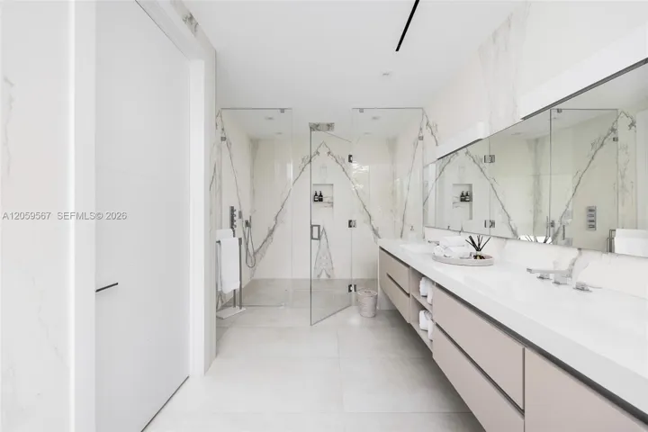 Primary bathroom with dual sink and spacious shower area