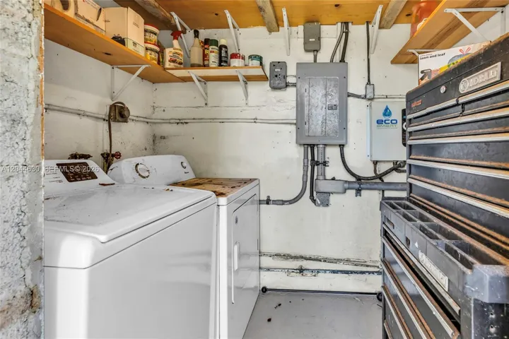 Tankless water heater & service panel inside laundry room