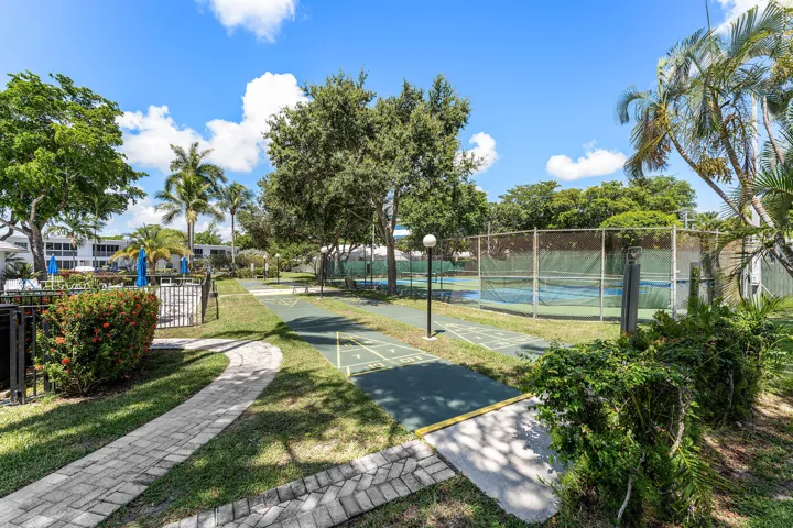 Rec center shuffleboard between tennis courts and pool.