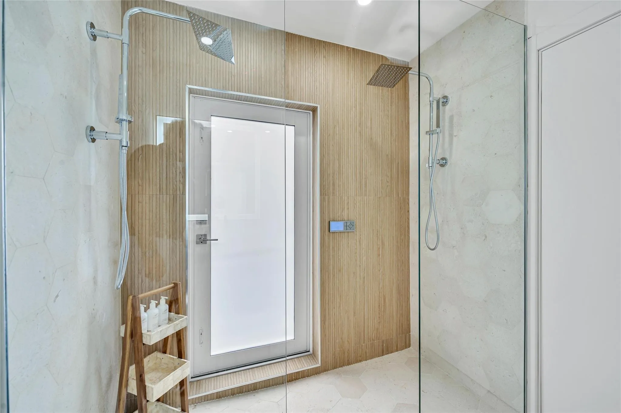 Guest Bathroom - Spa-like dual shower with Moen digital controls connected to high-end Delta Rainfall showerheads with separate handheld. This Bathroom doubles as a Cabana bath with outdoor shower and access to the pool! Vanity with lit mirror and power outlets in the vanity for hair driers etc.