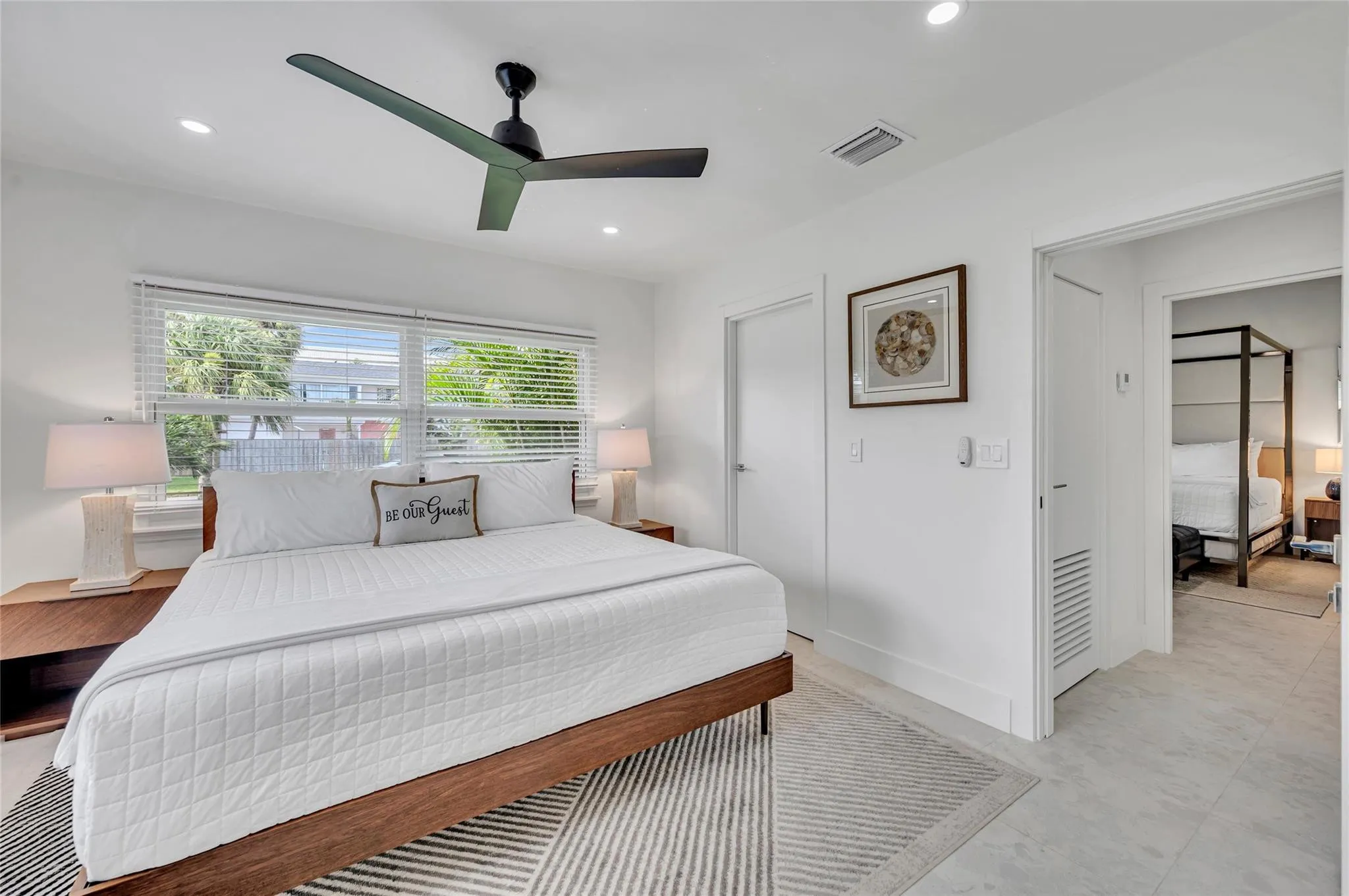 guest bedroom #3 has direct access to guest bathroom. features large walk in closet, ceiling fan, and tons of natural light!