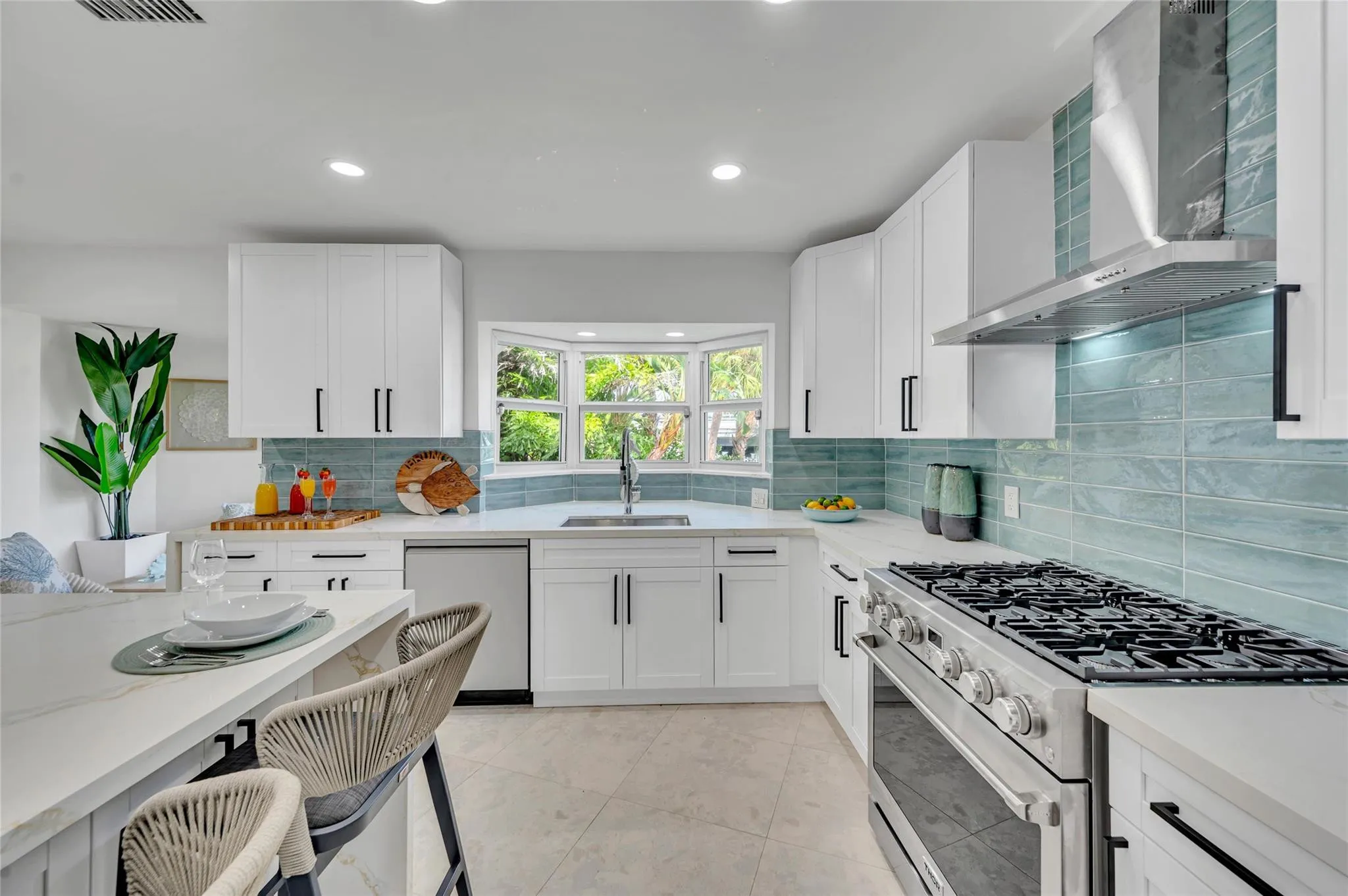 Solid wood cabinetry with soft-close hardware. Quartz countertops with stunning waterfall edge Massive island with seating for 10. High-end appliances: 36” natural gas oven range, vent hood, dishwasher, refrigerator, microwave