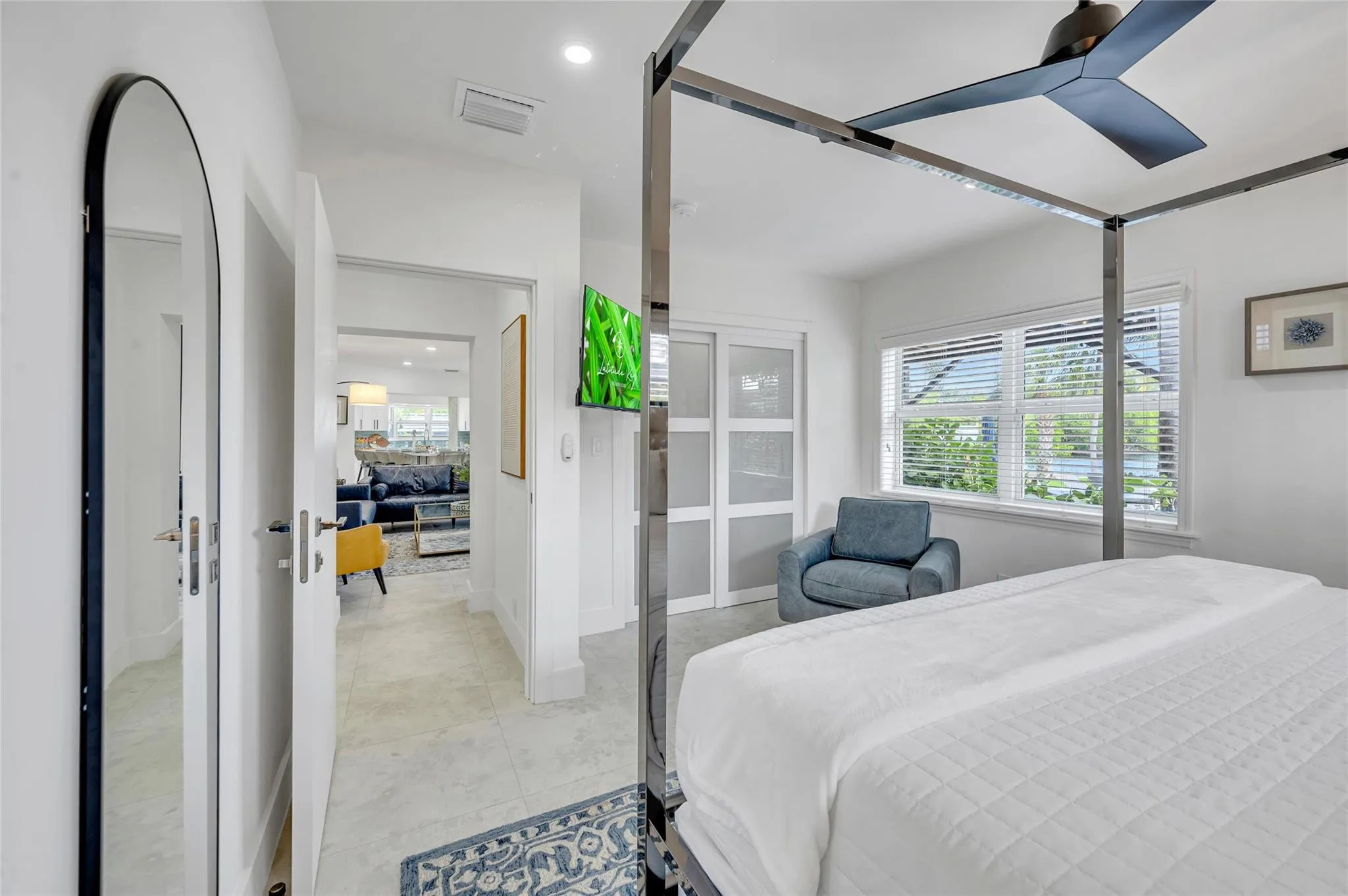 guest bedroom #4 has direct access to guest bathroom. features large sliding closet with built ins. can lights, and tons of natural light with views of the pool and canal!