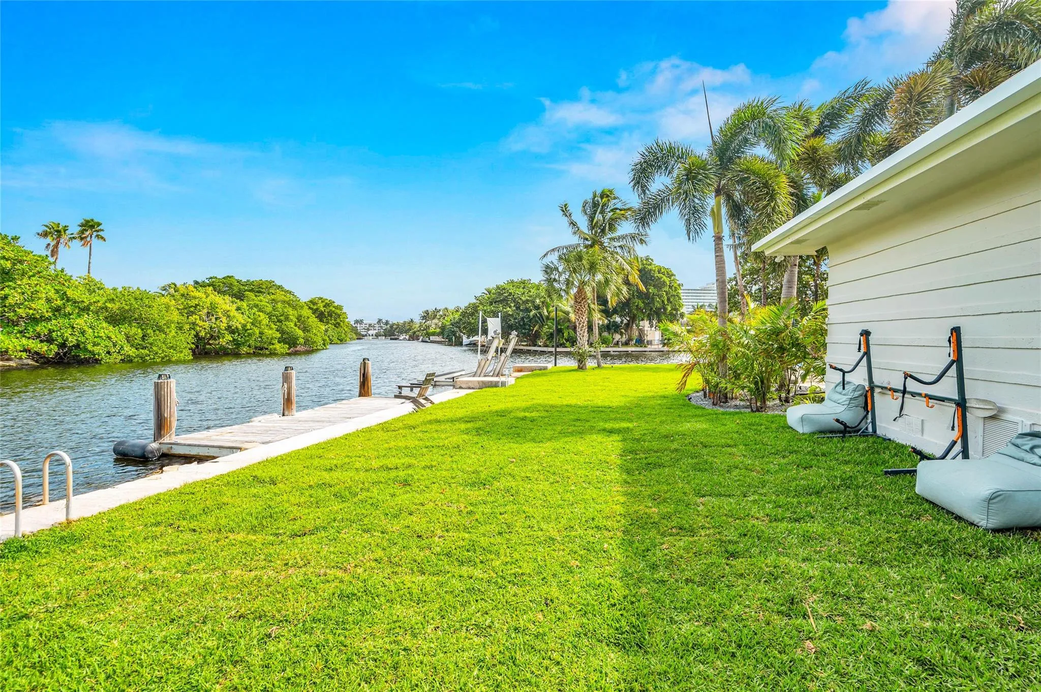 view of the dock and side yard. yard space is a rare commodity near the beach especially with this much waterfront allows for wide open views and space to play yard games with your family