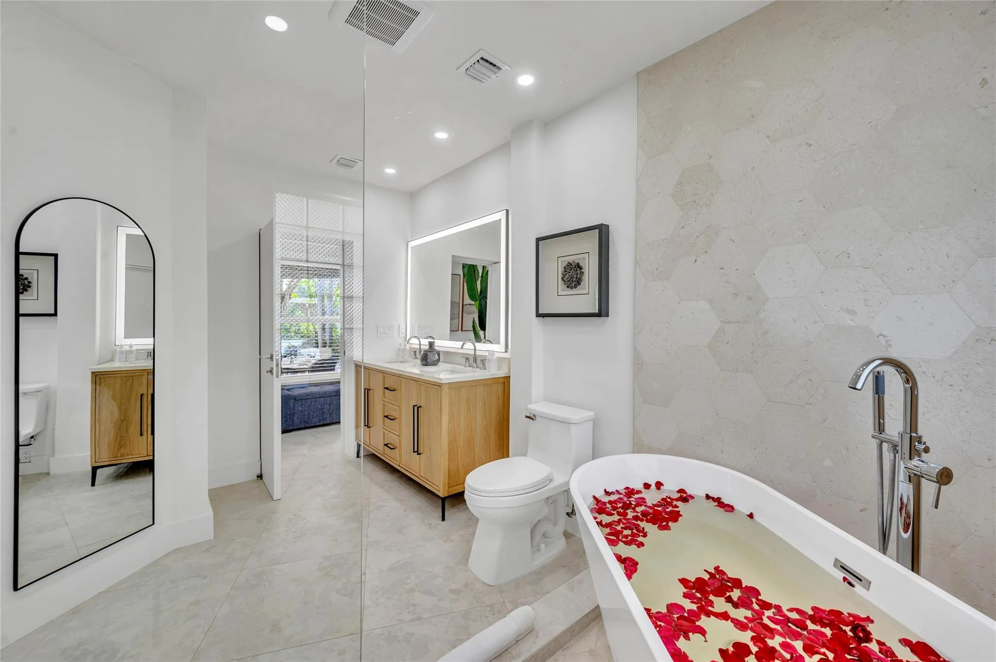 Spa-like master bathroom, Dual shower with Moen digital controls connected to high-end Delta shower head Rainfall showerheads with separate handheld and soaking tub. Dual vanities, with lit mirror and power outlets in the vanity for hair driers etc.