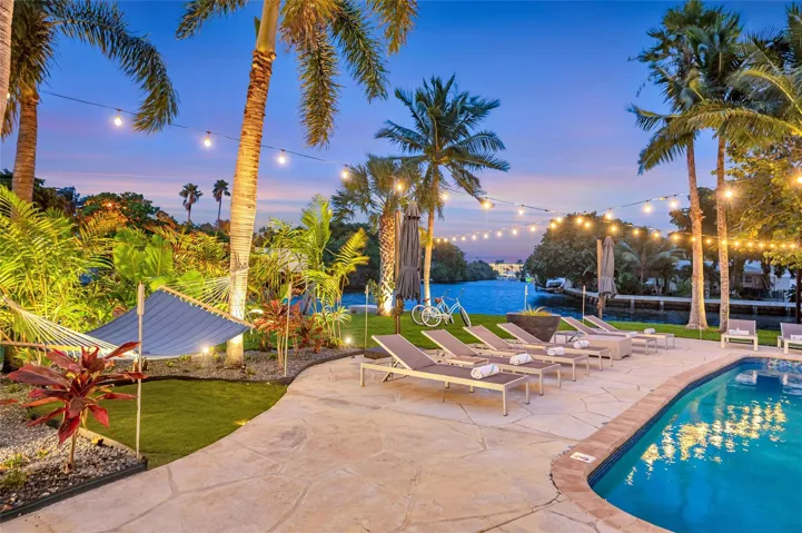 15x 30 heated pool with New Jandy pool equipment: variable-speed pump, salt system, iAqualink Wi-Fi control Fully renovated landscaping with new sod, Palm trees, flowers and plants, Wi-Fi-enabled sprinkler system, Custom landscape lighting including overhead string lights