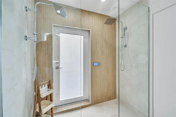 Guest Bathroom - Spa-like dual shower with Moen digital controls connected to high-end Delta Rainfall showerheads with separate handheld. This Bathroom doubles as a Cabana bath with outdoor shower and access to the pool! Vanity with lit mirror and power outlets in the vanity for hair driers etc.