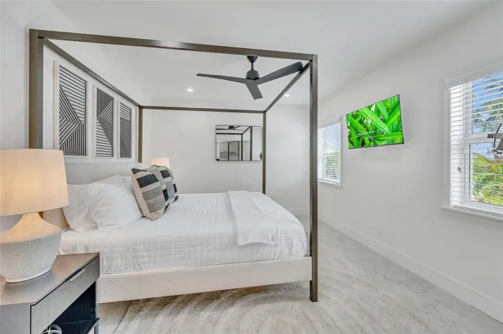 Primary Bedroom isolated from the guest bedrooms. Has a view to the back of pool and straight down the canal. Additionally a beautiful high end finishes in the primary bathroom and walk in closet.
