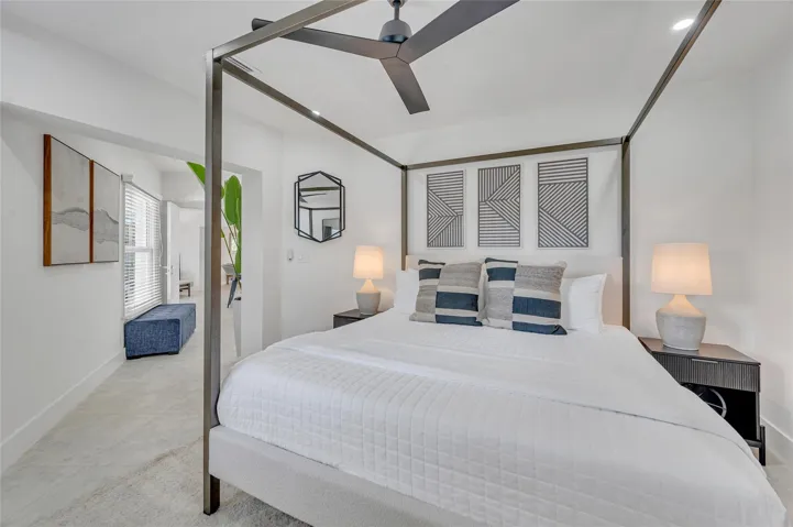 Primary Bedroom isolated from the guest bedrooms. Has a view to the back of pool and straight down the canal. Additionally a beautiful high end finishes in the primary bathroom and walk in closet.