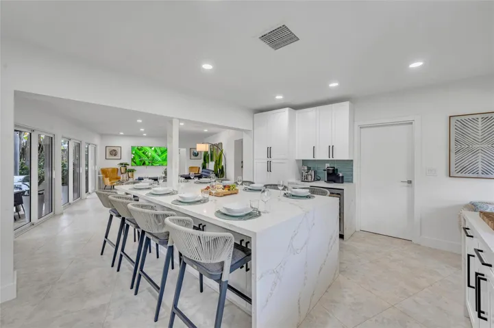 Solid wood cabinetry with soft-close hardware. Quartz countertops with stunning waterfall edge Massive island with seating for 10. High-end appliances: 36” natural gas oven range, vent hood, dishwasher, refrigerator, microwave