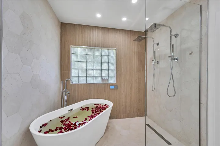 Spa-like master bathroom, Dual shower with Moen digital controls connected to high-end Delta Rainfall showerheads with separate handheld and soaking tub. Dual vanities, with lit mirror and power outlets in the vanity for hair driers etc.