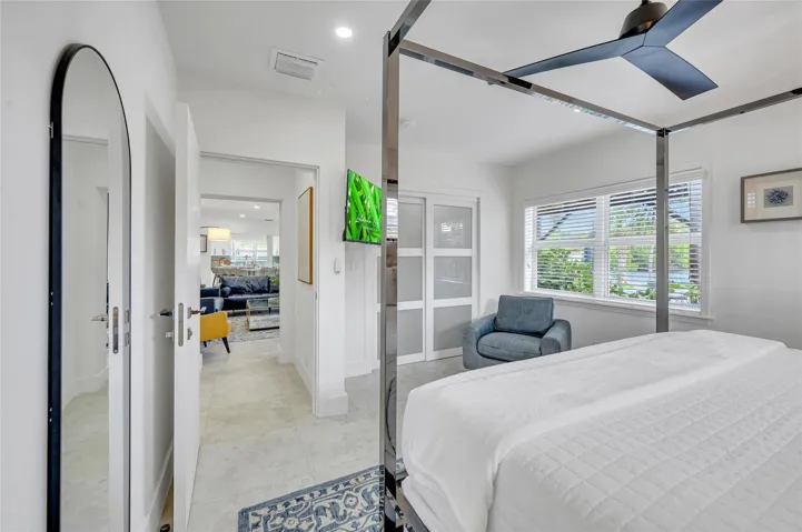 guest bedroom #4 has direct access to guest bathroom. features large sliding closet with built ins. can lights, and tons of natural light with views of the pool and canal!