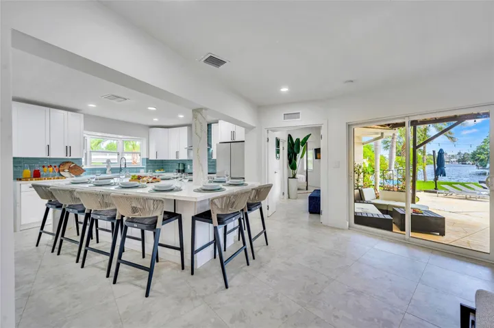 Solid wood cabinetry with soft-close hardware. Quartz countertops with stunning waterfall edge Massive island with seating for 10. High-end appliances: 36” natural gas oven range, vent hood, dishwasher, refrigerator, microwave