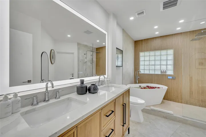 Spa-like master bathroom, Dual shower with Moen digital controls connected to high-end Delta Rainfall showerheads with separate handheld and soaking tub. Dual vanities, with lit mirror and power outlets in the vanity for hair driers etc.
