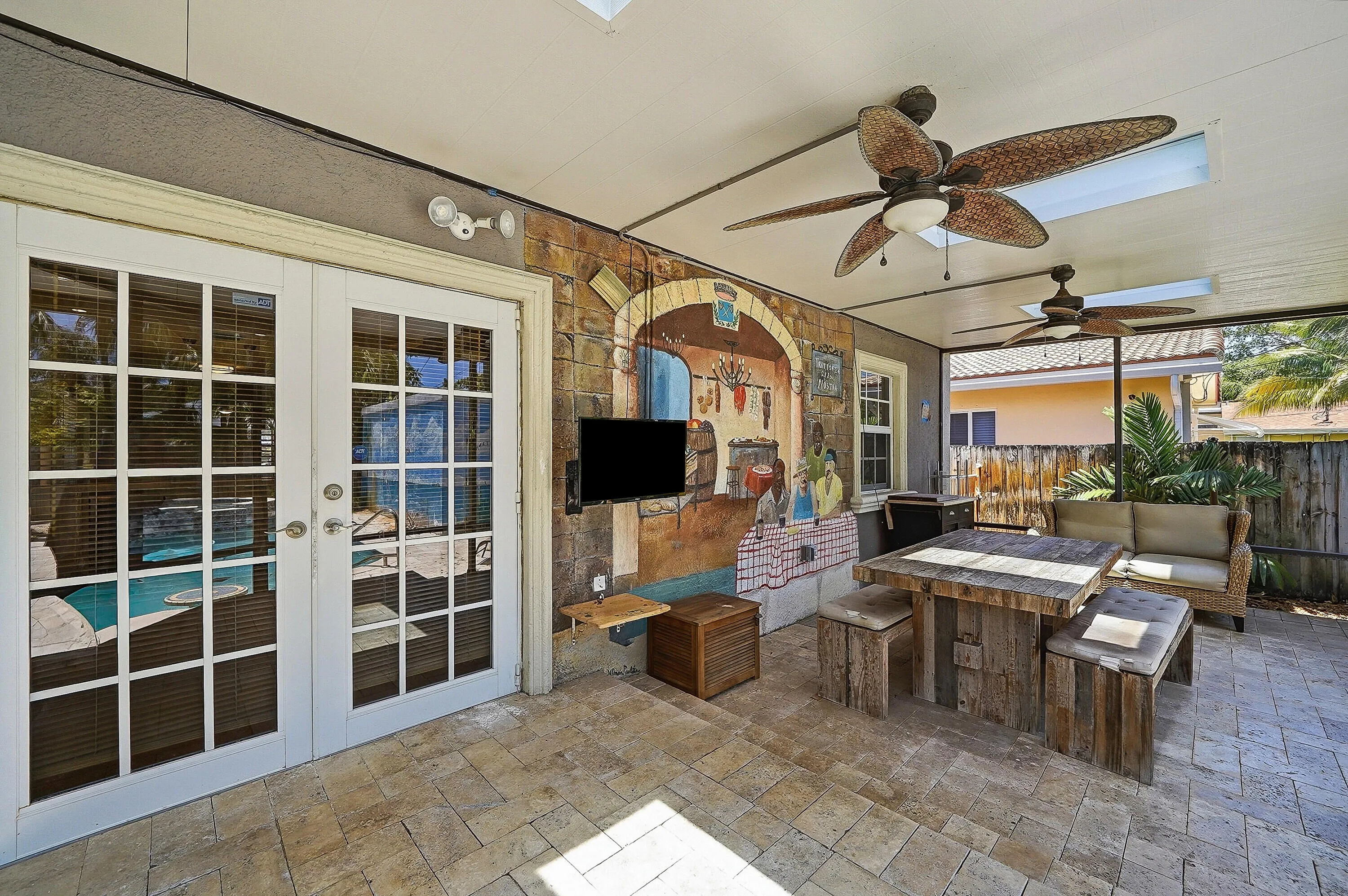 Covered and screened patio with TV
