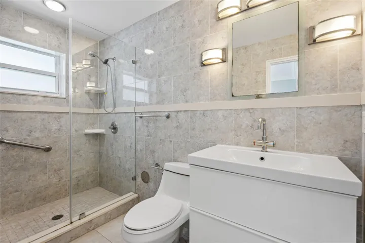 All tiled with large step in shower-glass door