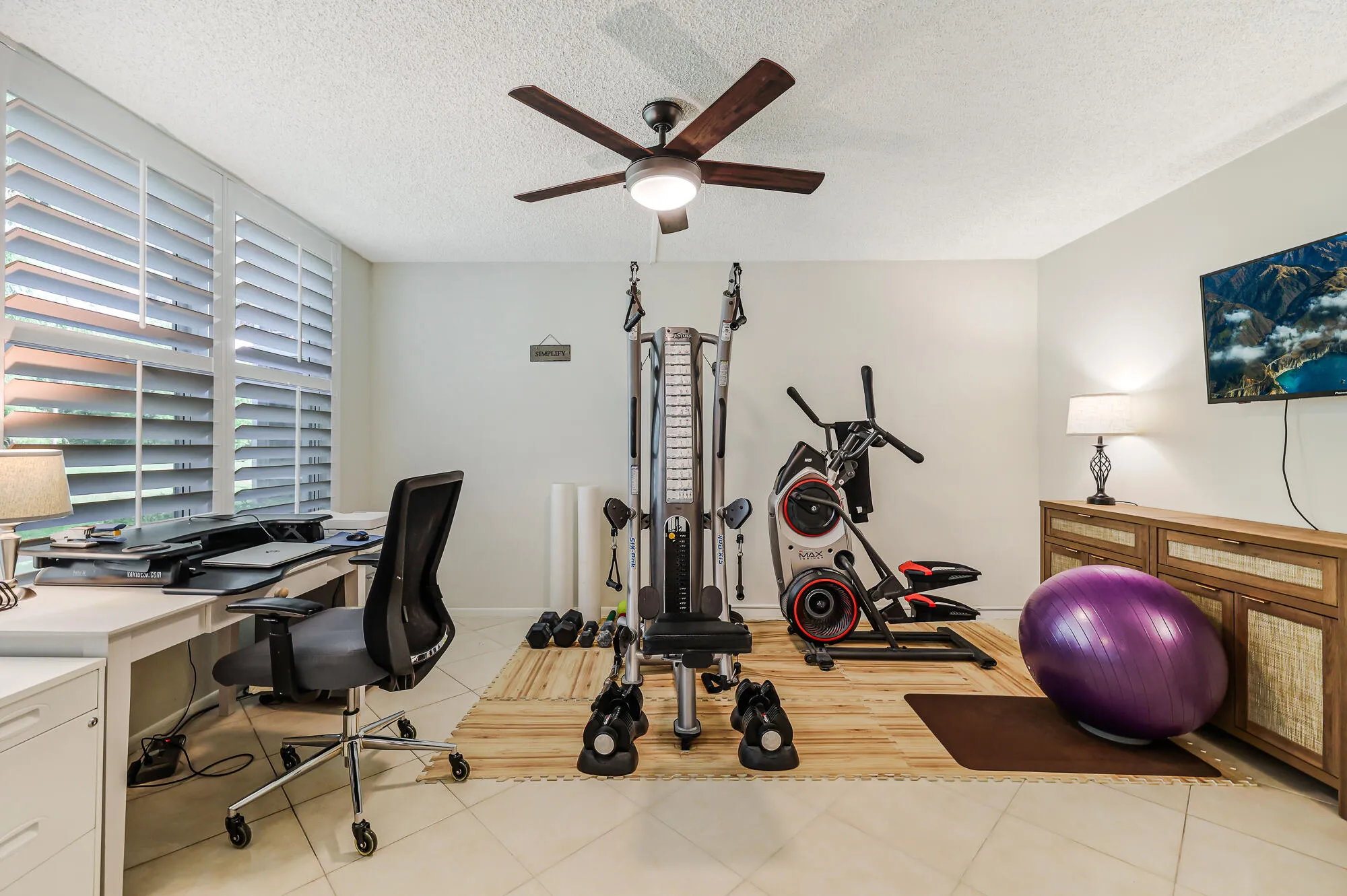 Den that is currently being used as a work out room/office.