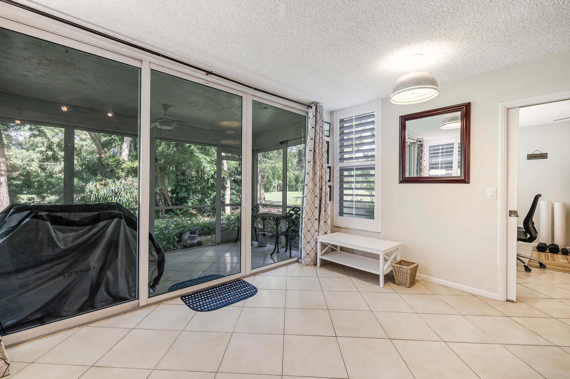 Living room looks out to the screened in patio