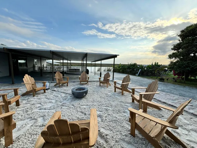 Outdoor fire pit area with seating, featuring a gravel ground cover