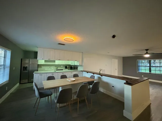 Kitchen area featuring white cabinetry, light-toned countertops, and stainless steel appliances
