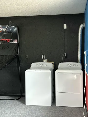 Laundry area with a top-load washer and front-load dryer