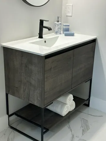 Modern vanity with a white rectangular basin sink and matte black faucet