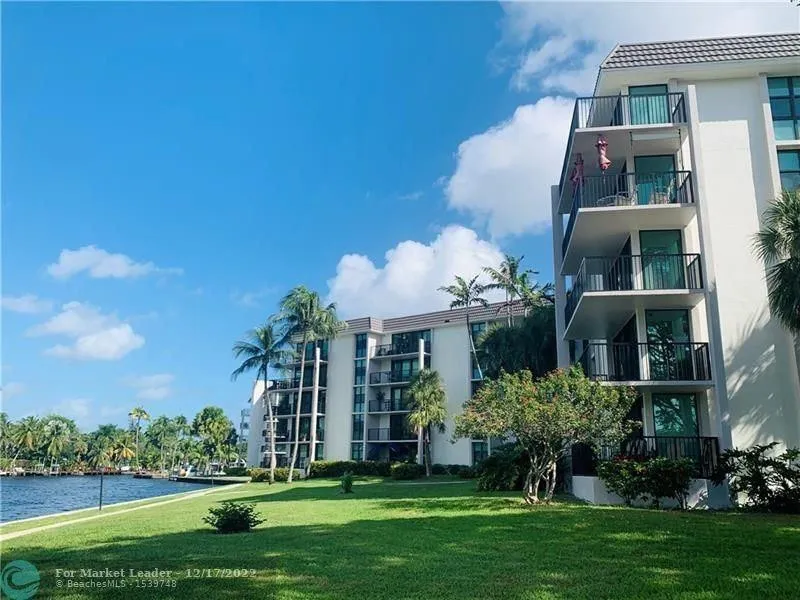 Multistory building with multiple private balconies featuring black railings and expansive glass sliding doors