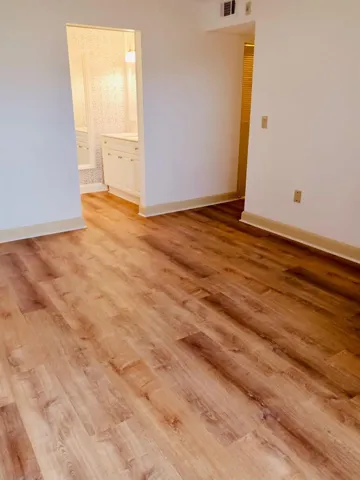 Wood-finish flooring throughout, with neutral wall paint and white baseboards