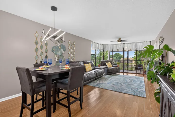 Dining and living areas open to large balcony.