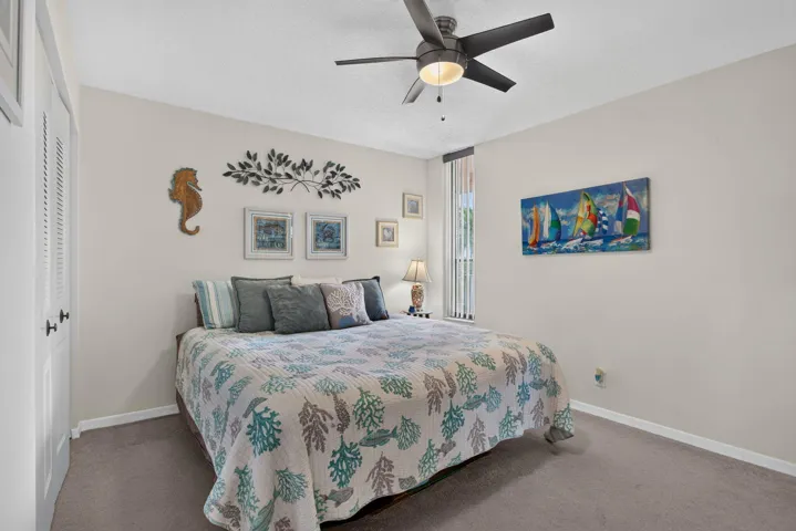 Guests will love the pocket door for privacy in the large bedroom with plush carpeting.