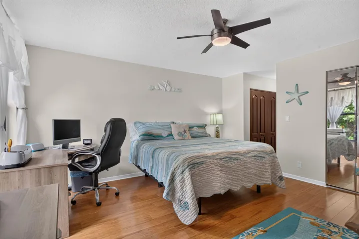 Fall in love in your fabulous primary suite with bamboo flooring. IMPACT WINDOWS to enjoy evening sunsets over the lake.