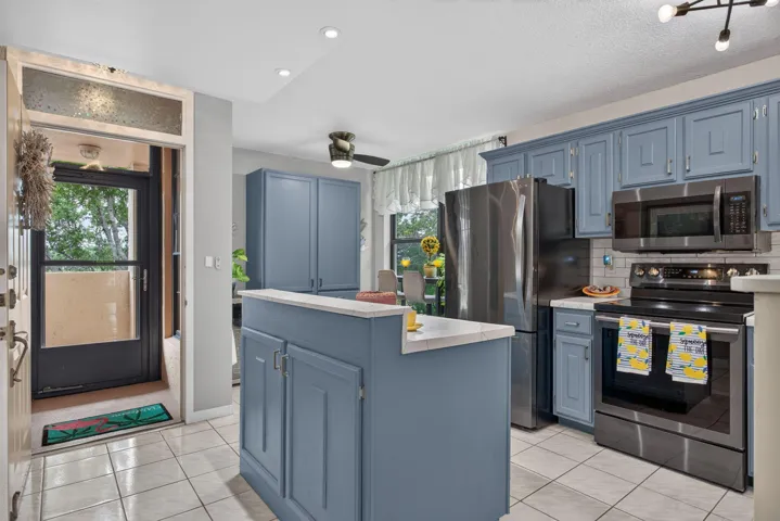 Gorgeous kitchen is wide open. Featuring LG and Samsung S/S appliances.