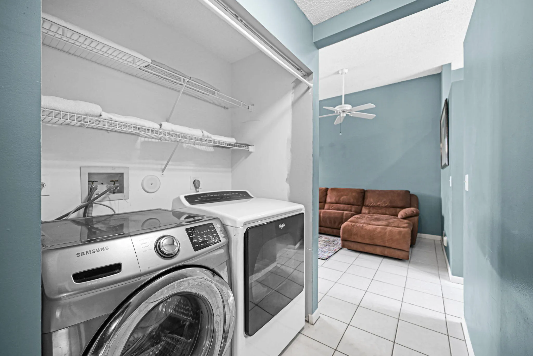 Dedicated laundry area featuring a front-loading washer and dryer