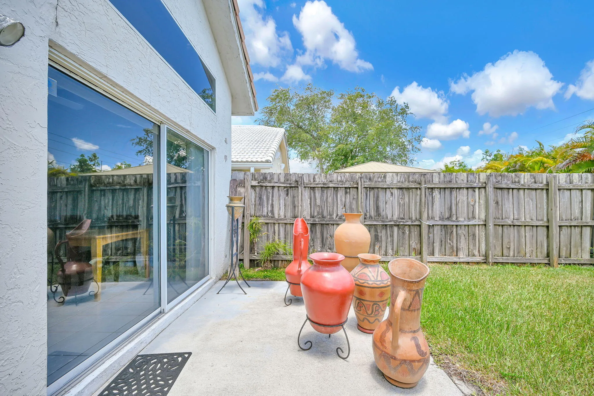 Concrete patio area with a sliding glass door