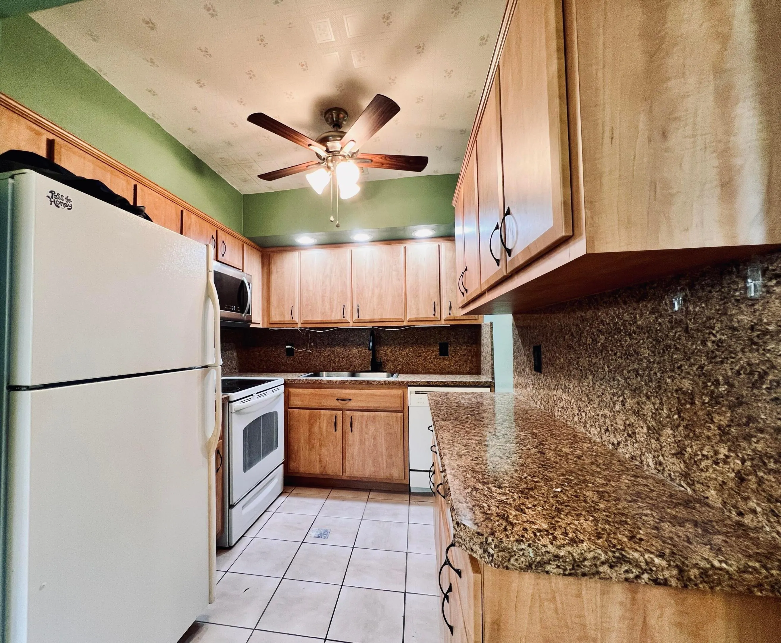 Pretty Updated Kitchen With Rich Wood Tone Cabinets, Granite Look Counters. Full Appliance Package - Including A Dishwasher