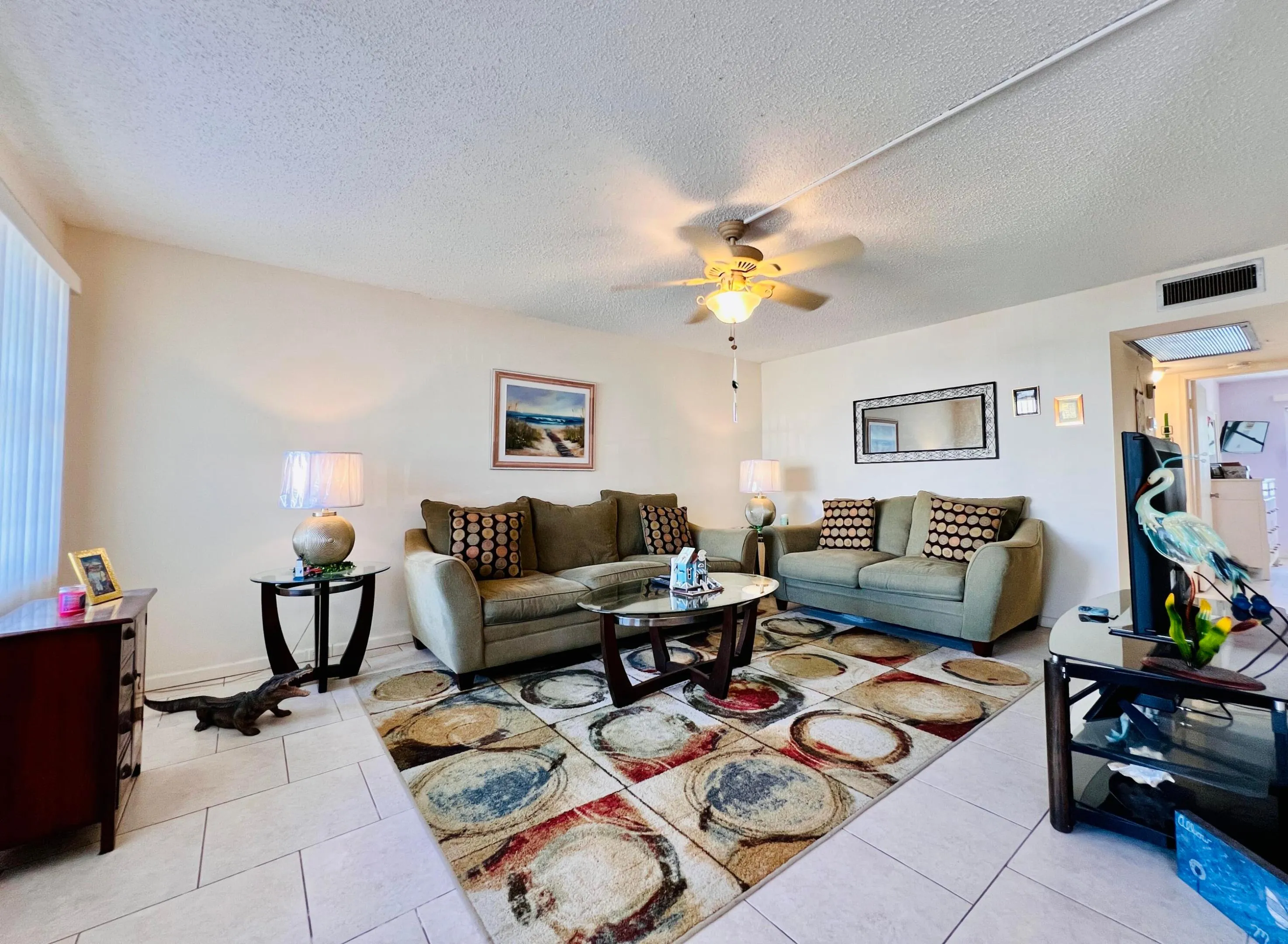 Spacious Living Area With Neutral Tile Flooring. Sold Furnished.