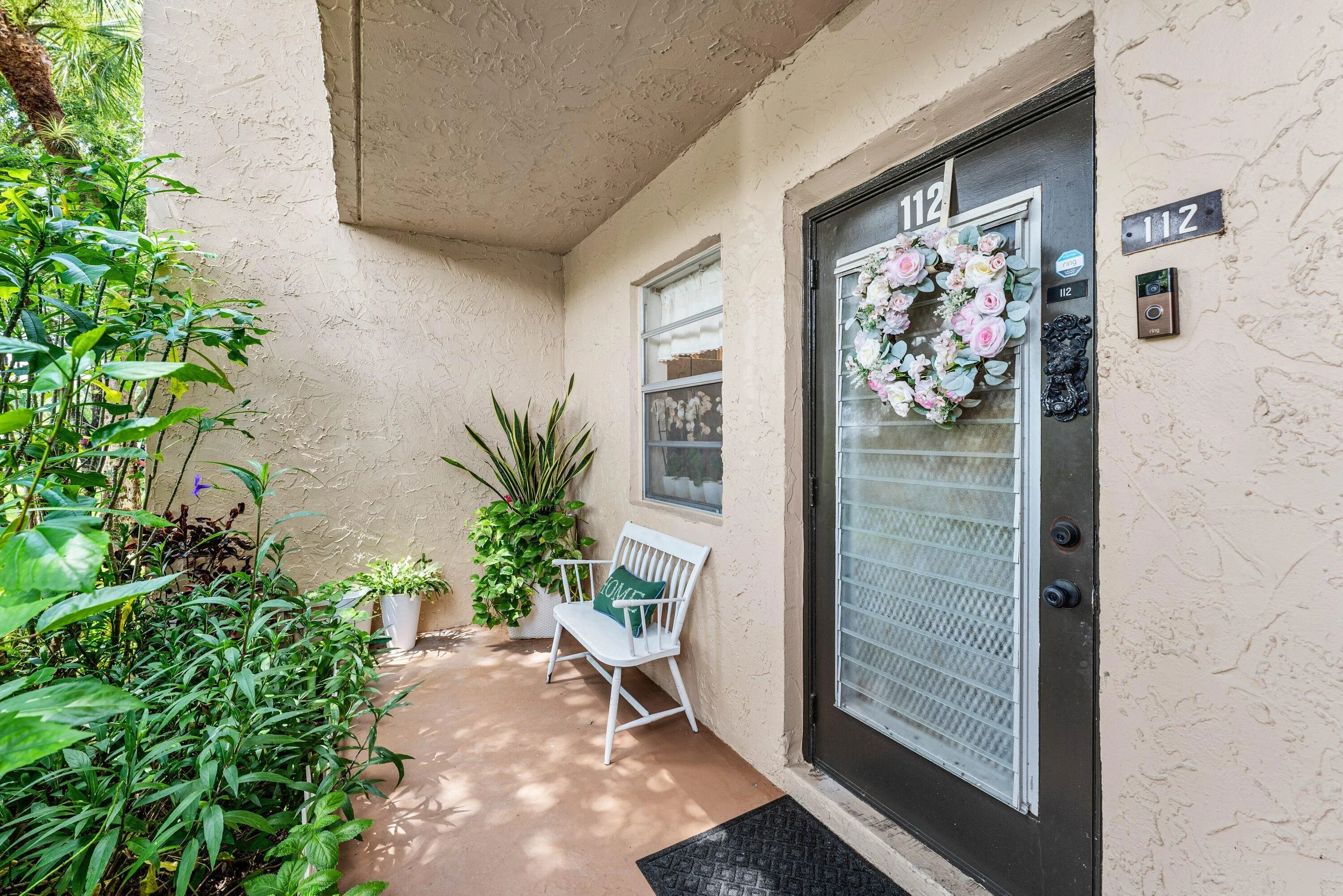 Enjoy a relaxing moment on the front porch with a great view of greenery