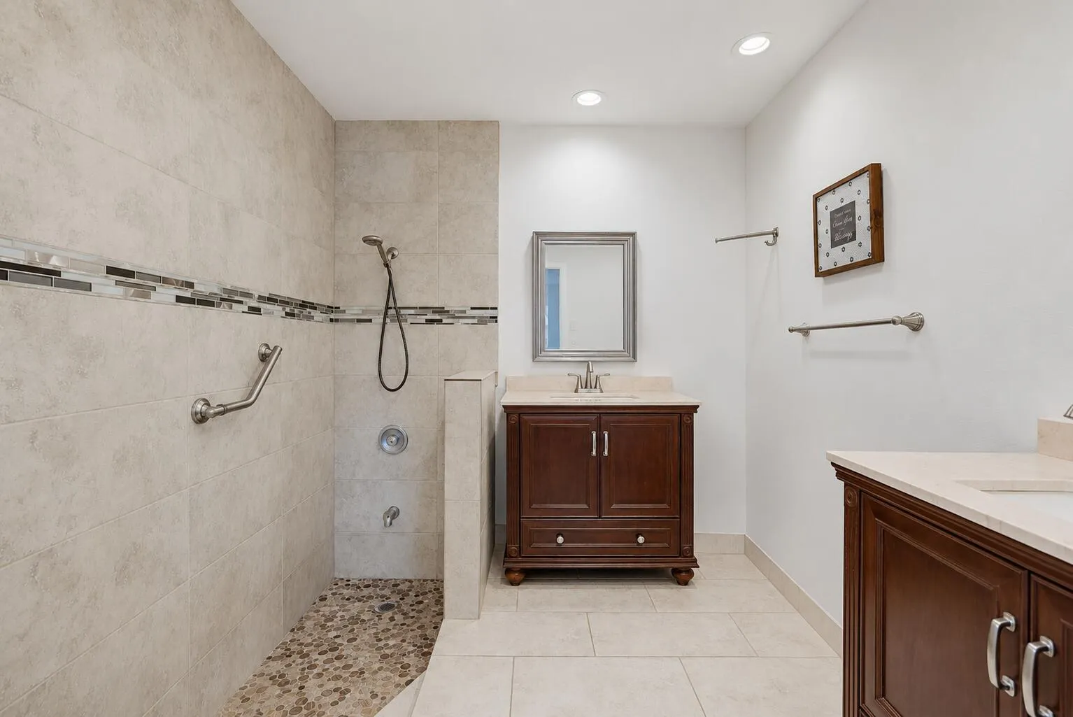 Large walk-in shower upgraded room with tile and double vanities with custom mirrors
