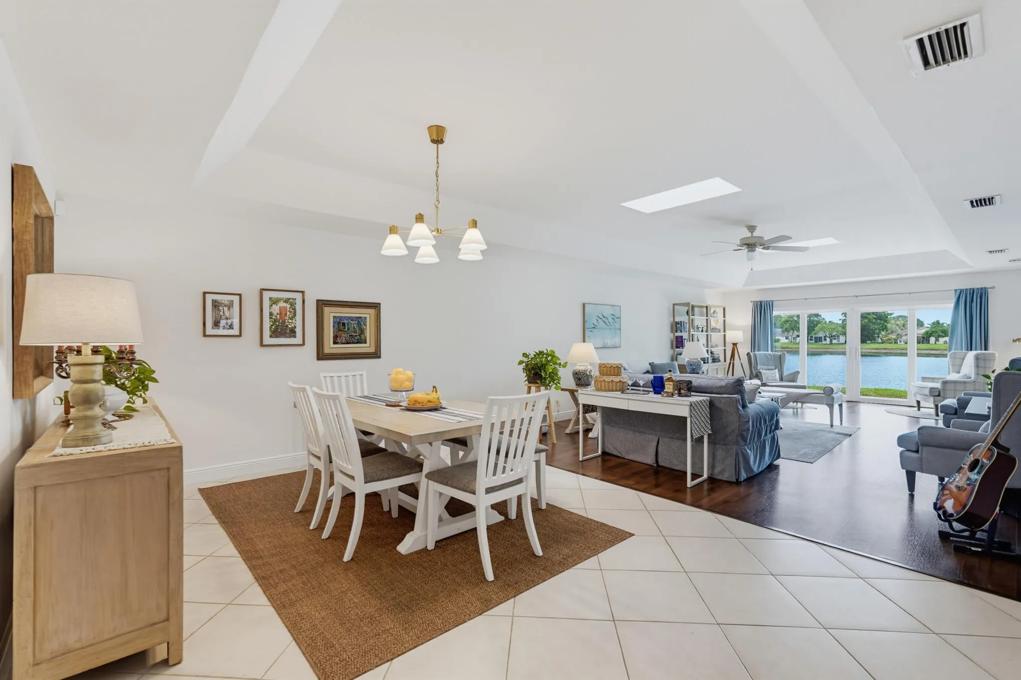 Tiled dining area and great room separated by laminate flooring,