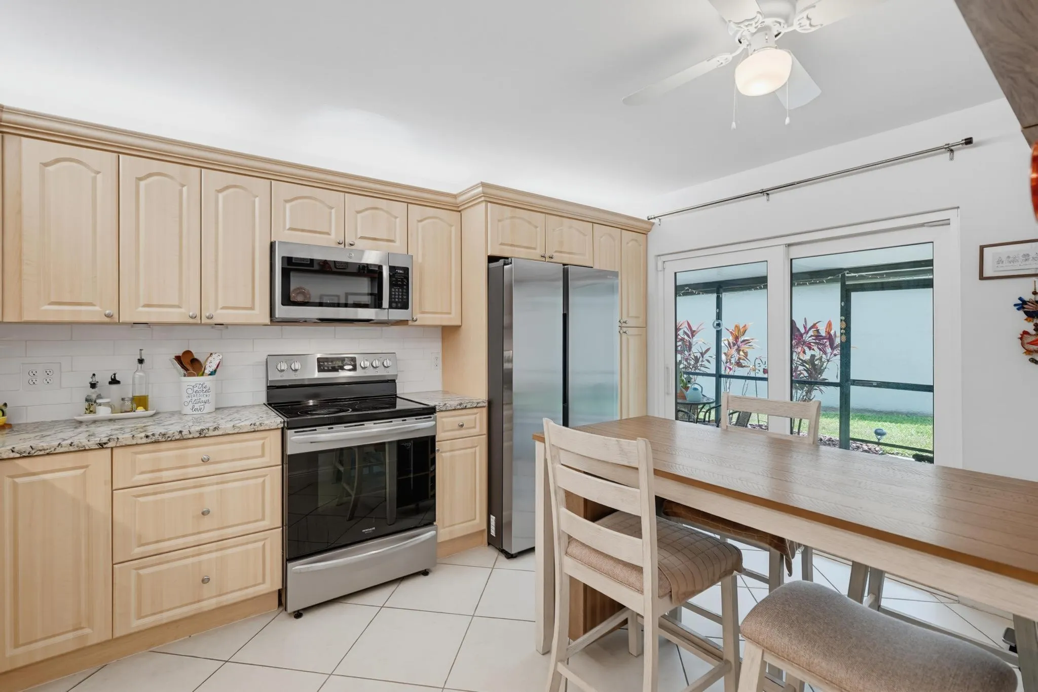 Covered screened porch on side yard. Newer stainless steel appliances