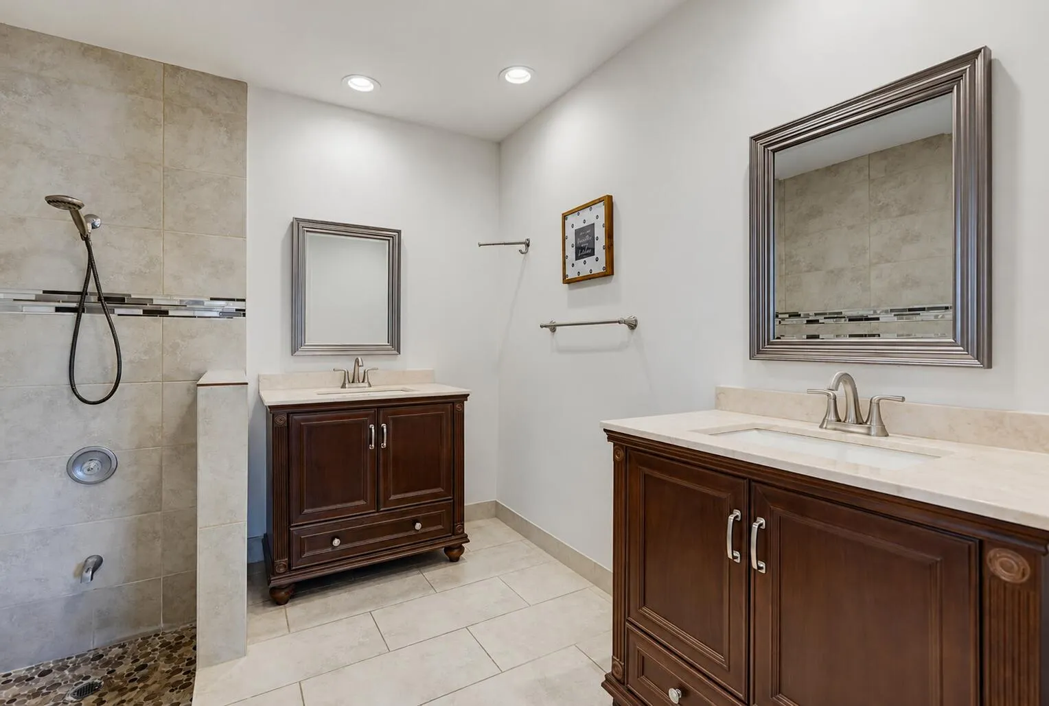 Beautiful vanities and bathroom tile floors and shower