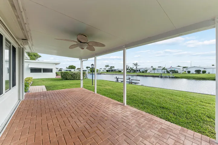 Back porch overlooking Main Canal. Faces East for Gulfstream breezes.