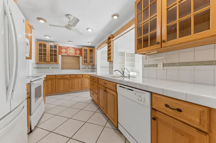 Kitchen cabinetry replaced and additional cabinetry added. Tiled countertops.