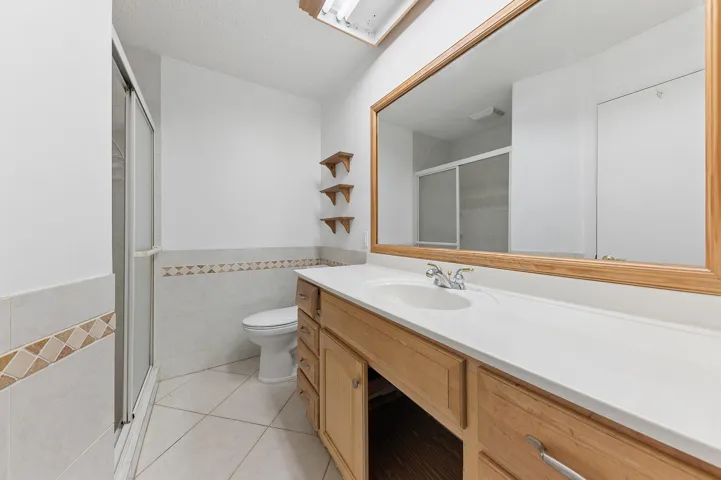 Master bathroom with enclosed shower and linen closet