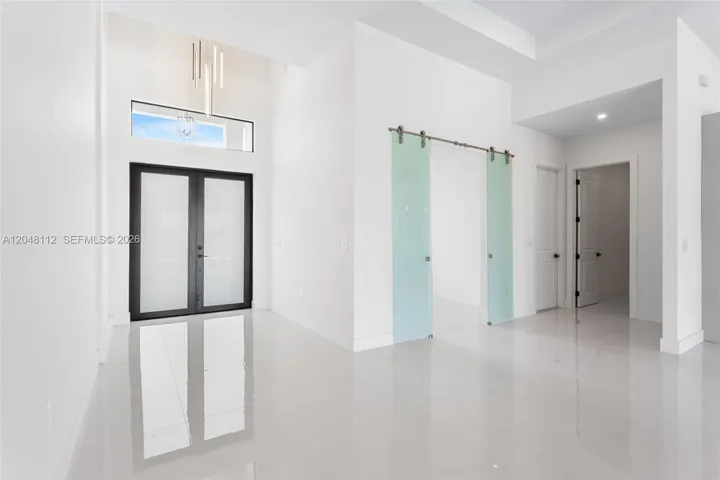 Enter through the COVERED FRONT PORCH and GRAND DOUBLE DOORS into a SOARING 16-FT FOYER, where a NEUTRAL PALETTE OF WHITE, LIGHT GRAY, and CASHMERE WELCOMES YOU HOME!