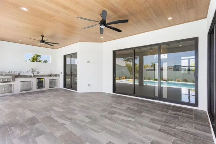 Covered lanai with flat wooden ceiling
