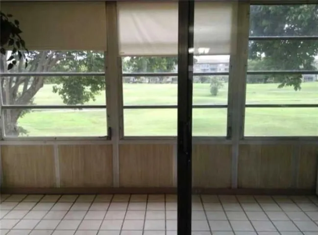 Enjoy Relaxing in this Enclosed Patio Overlooking the Golf Course