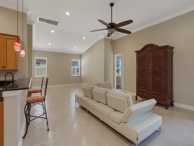 Living room featuring crown molding and recessed lighting